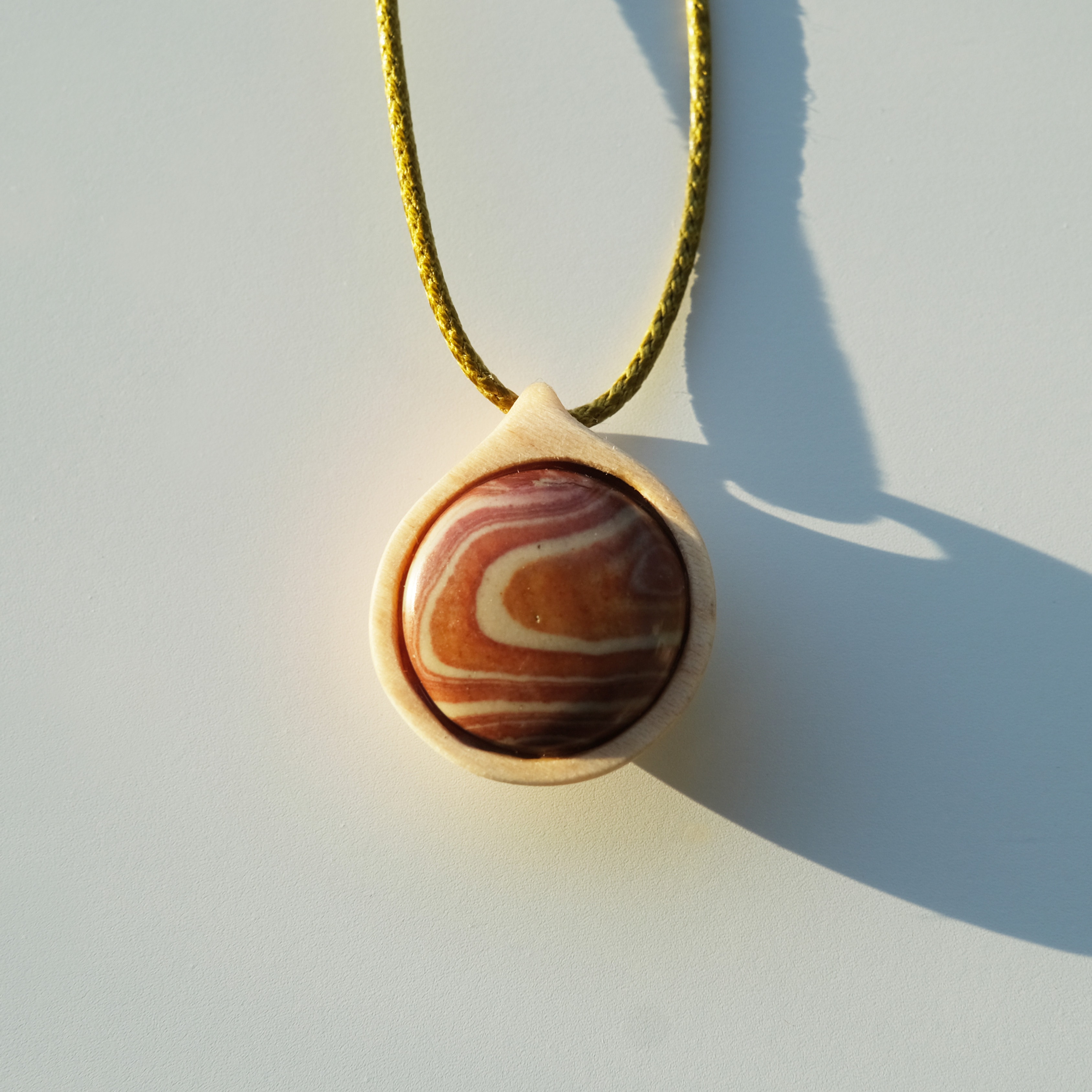 Jasper gemstone in maple wood pendant necklace on light green cord